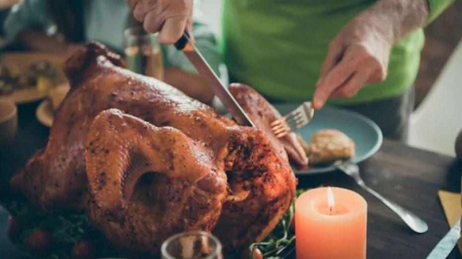 Thanksgiving turkey gets cut with fork and knife