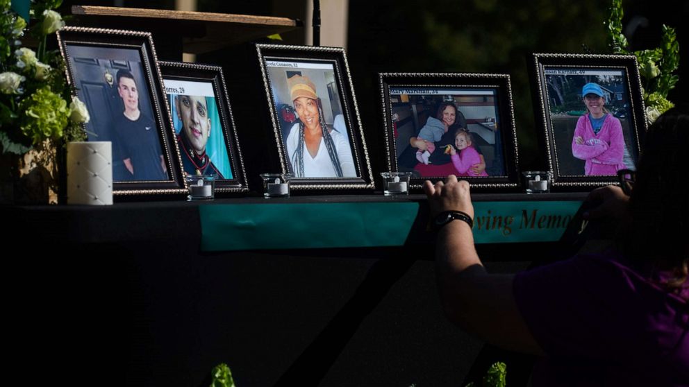 PHOTO: People set up a memorial table with images of the shooting victims for a vigil in the Hedingham neighborhood, Oct. 15, 2022, in Raleigh, N.C.