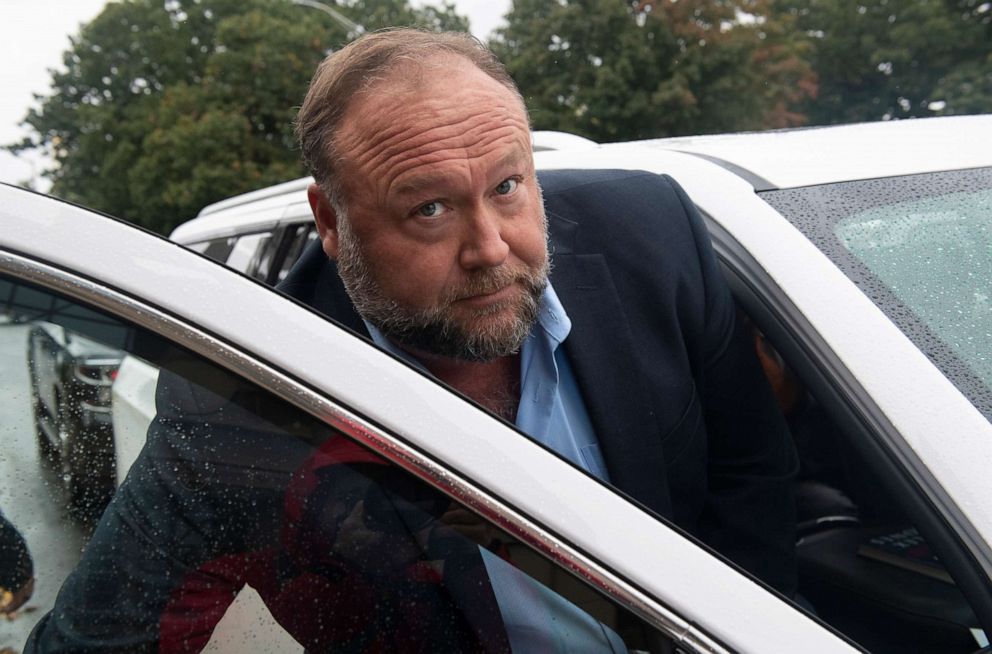 PHOTO: Conspiracy theorist Alex Jones enters a private car after talking to the media outside State of Connecticut Superior Court during the Sandy Hook hoax defamation trialin Waterbury Conn., Oct. 4, 2022 . 