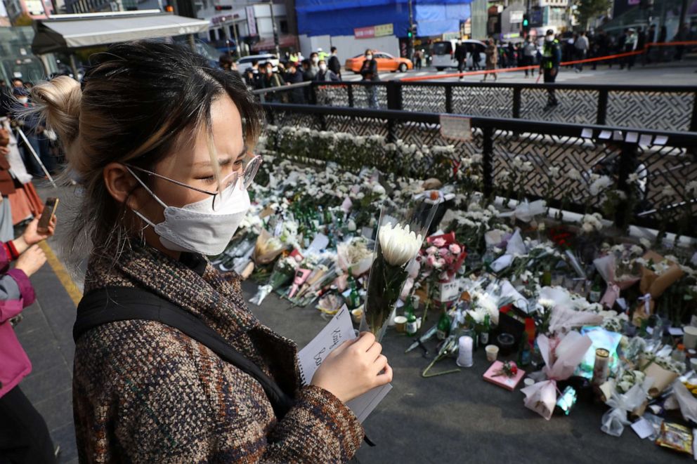 PHOTO: A woman pays tribute for the victims of the Halloween celebration stampede, on the street near the scene on Oct. 31, 2022, in Seoul, South Korea. 