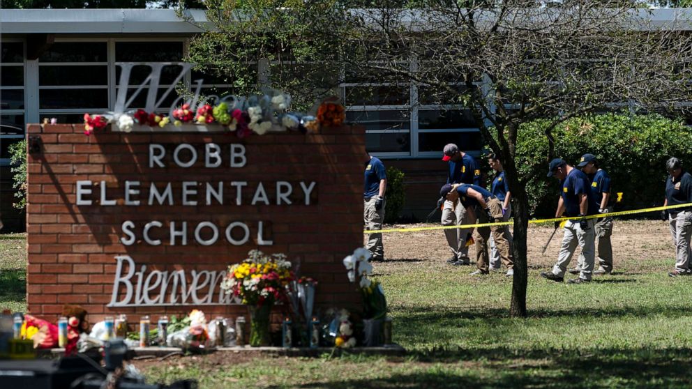 FILE PHOTO: Investigators search for evidences outside Robb Elementary School in Uvalde, Texas, on May 25, 2022, one day after an 18-year-old gunman killed 19 students and two teachers.