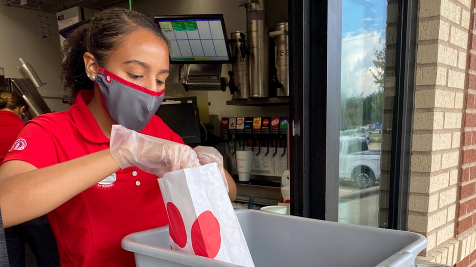 Chick-fil-A worker puts food in bag