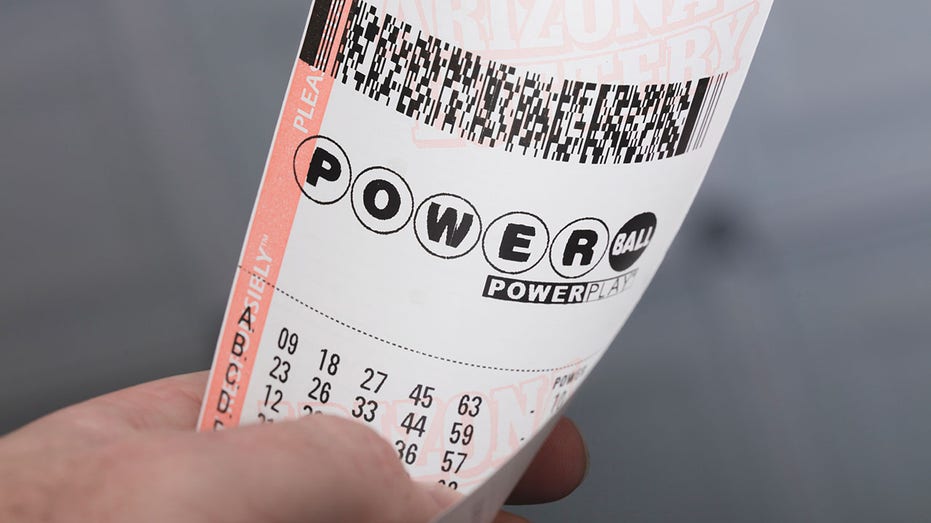 A person holding a Powerball ticket