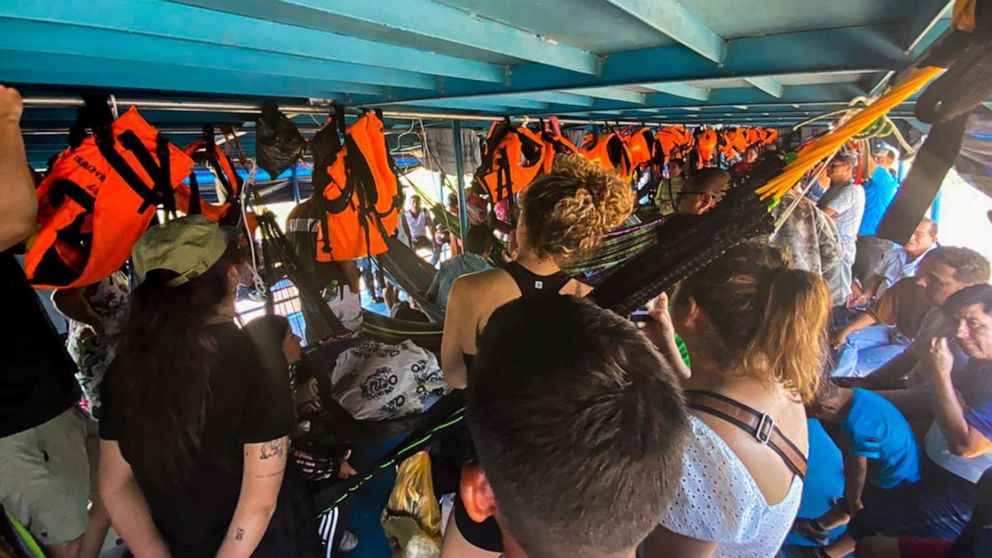 PHOTO: Foreign and Peruvian tourists wait in the boat where they have been detained at the Cuninico community in Loreto, Peru, Nov. 4, 2022. 