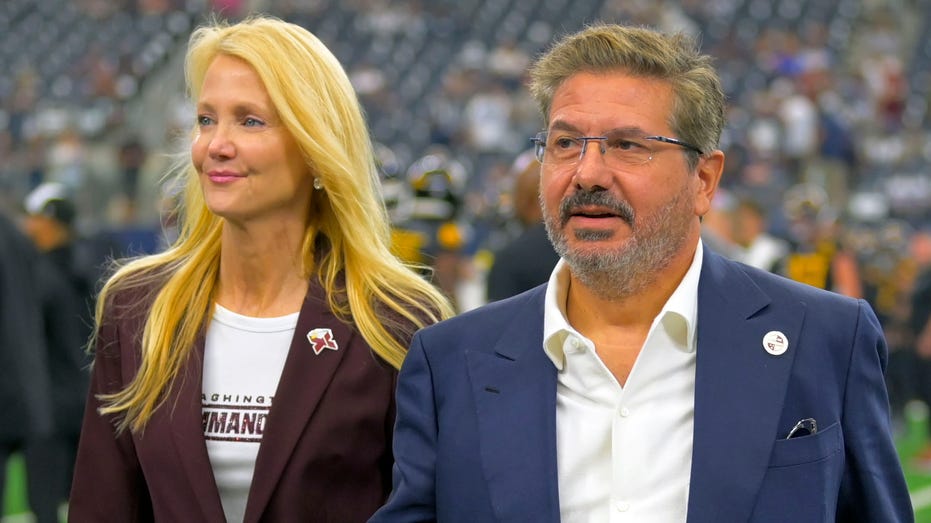 Dan and Tanya Snyder walk on field