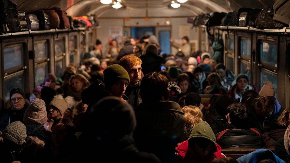 PHOTO: FILE - Displaced Ukrainians onboard a Poland bound train in Lviv, western Ukraine, March 13, 2022.