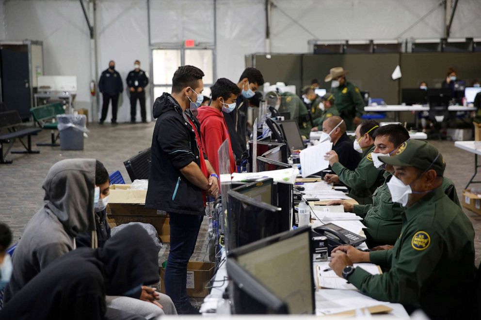 PHOTO: Migrants are processed at the intake area in the Department of Homeland Security holding facility run by the Customs and Border Patrol (CBP) on March 30, 2021 in Donna, Texas.