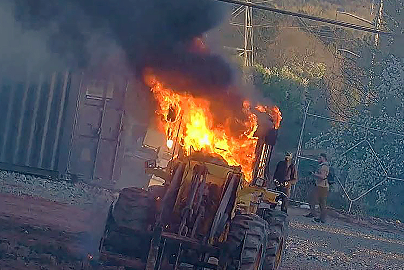 This image provided by the Atlanta Police Department shows construction equipment set on fire Saturday, March 4, 2023 by a group protesting the planned public safety training center, according to police. (Atlanta Police Department via AP)