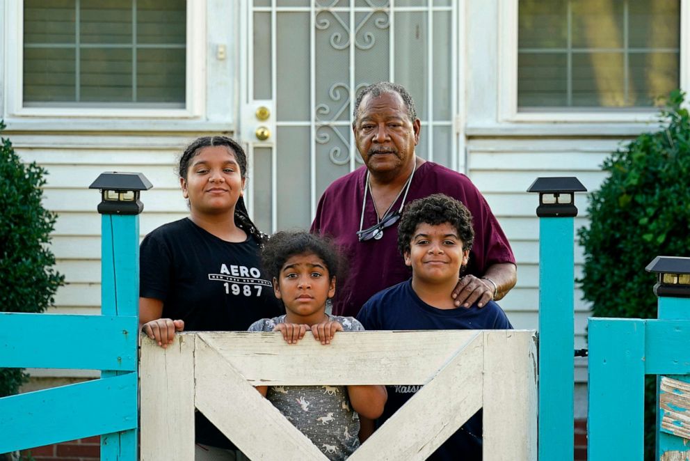 PHOTO: In this Sept. 23, 2022, file photo, Angelo Bernard, who lives near the Denka Performance Elastomer Plant, poses with his grandchildren who are visiting him for the weekend, at his home in Reserve, La.
