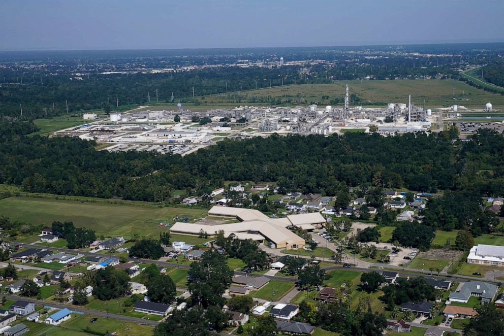 PHOTO: In this Sept. 23, 2022, file photo, the Fifth Ward Elementary School and residential neighborhoods sit near the Denka Performance Elastomer Plant, back, in Reserve, La.