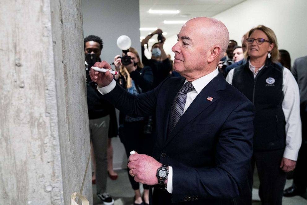 PHOTO: DHS Secretary Alejandro Mayorkas signs a beam during a ribbon cutting ceremony for the new DC Emergency Operations Center as FEMA Administrator Deanne Criswell looks on, in the Navy Yard neighborhood on Feb. 27, 2023.