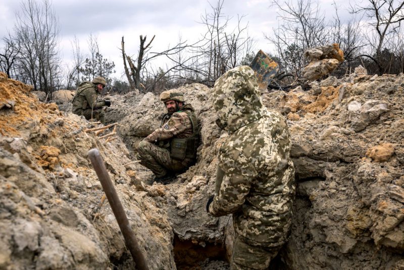 BAKHMUT, UKRAINE - MARCH 05: Ukrainian infantrymen with the 28th Brigade take cover in a partially dug trench along the frontline on March 05, 2023 outside of Bakhmut, Ukraine. Russian forces have been attacking Ukrainian troops as part of an offensive to encircle Bakhmut in Ukraine's eastern Donbas region. (Photo by John Moore/Getty Images)