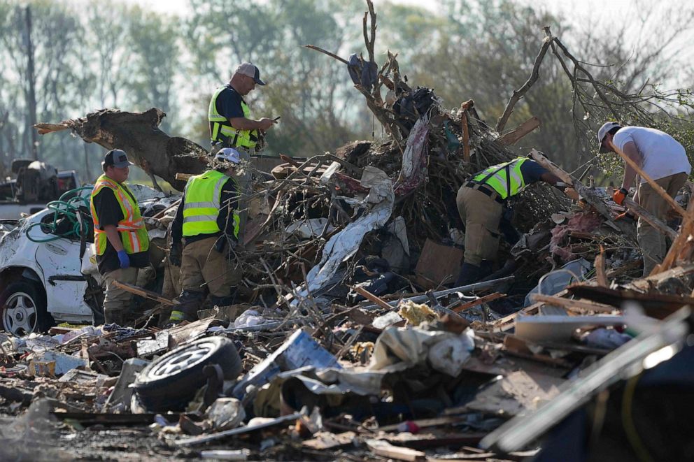 PHOTO: Emergency rescuers and first responders climb through a tornado demolished mobile home park, Mar. 25, 2023, in Rolling Fork, Miss.