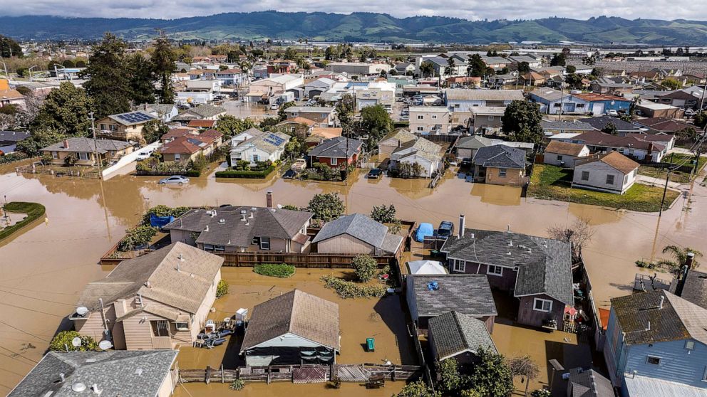 PHOTO: In this March 13, 2023, file photo, floodwaters surround homes and vehicles in the community of Pajaro in Monterey County, Calif.