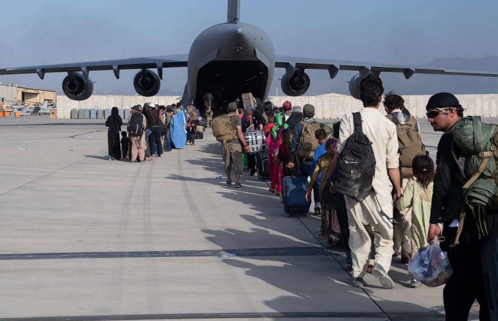 PHOTO: U.S. Air Force loadmasters and pilots load passengers aboard a U.S. Air Force C-17 Globemaster III in support of the Afghanistan evacuation at Hamid Karzai International Airport in Kabul, Afghanistan, Aug. 24, 2021.