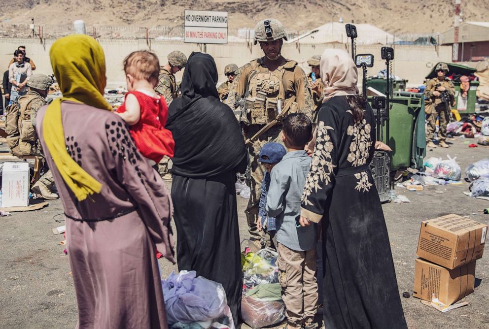 PHOTO: U.S. Marines with the 24th Marine Expeditionary Unit process evacuees as they go through the Evacuation Control Center during an evacuation at Hamid Karzai International Airport, Kabul, Afghanistan, Aug. 28.