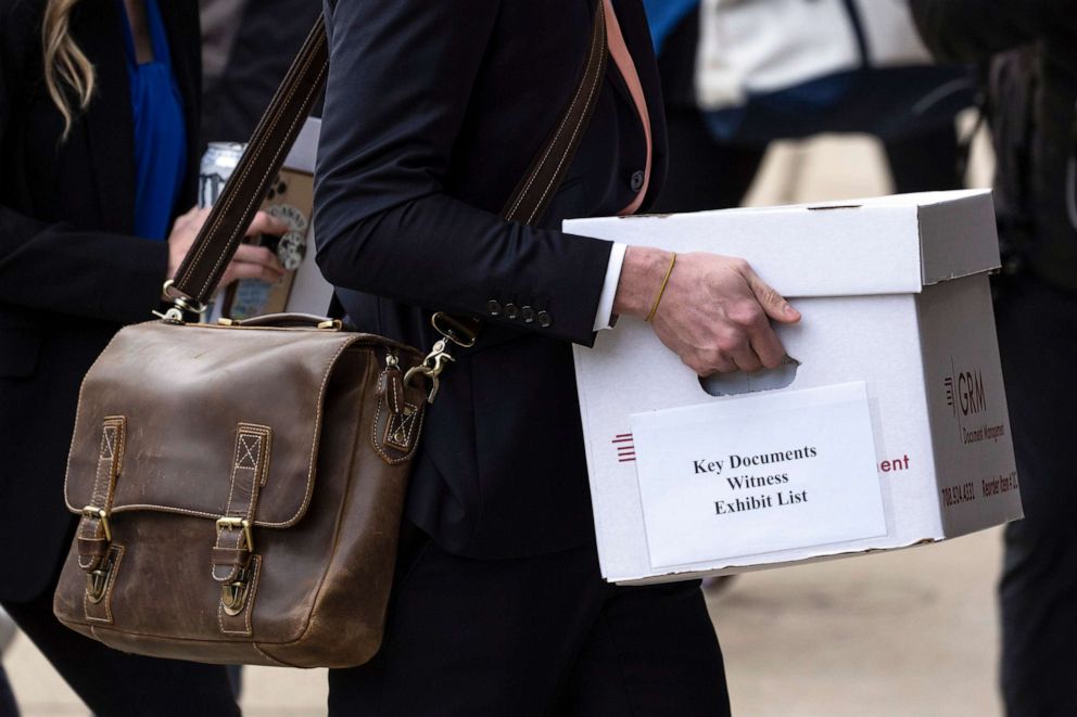 PHOTO: A representative of Fox News carries as box as they arrive at the justice center in Wilmington, Del., for the Dominion Voting Systems' defamation lawsuit against Fox News, Tuesday, April 18, 2023.