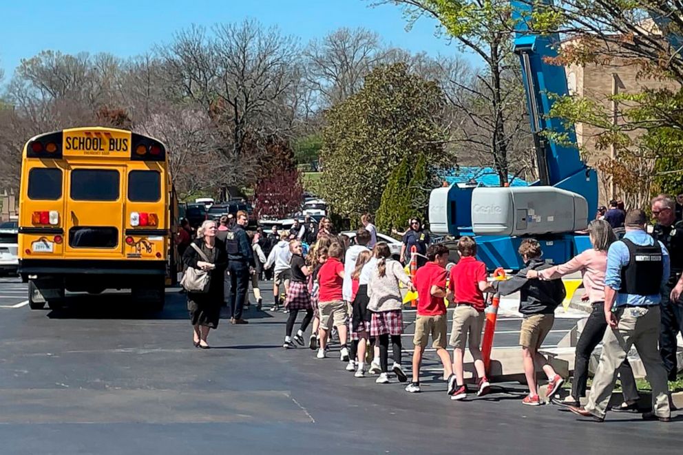 PHOTO: Children from The Covenant School, a private Christian school in Nashville, Tenn., hold hands as they are taken to a reunification site at the Woodmont Baptist Church after a deadly shooting at their school on Monday, March 27, 2023.