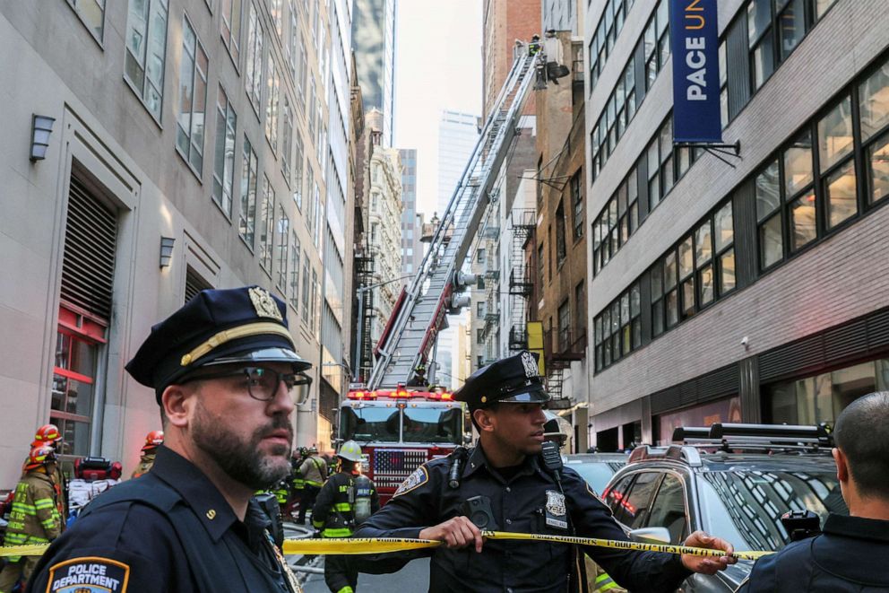 PHOTO: Police officers cordon off the area as firefighters work at the site of a collapsed parking garage in the Manhattan borough of New York City, April 18, 2023.