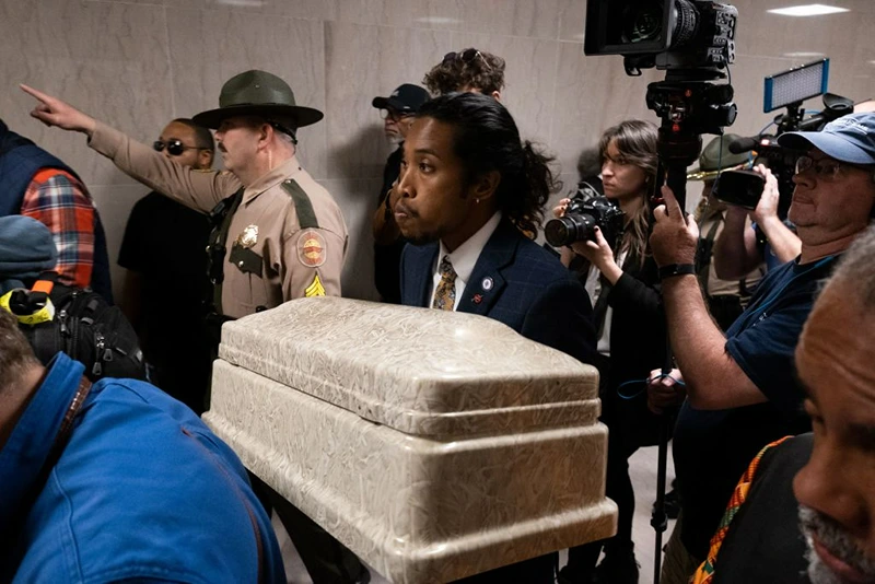 Democratic representative Justin Jones of Nashville walks with a casket in hand, representing the lives lost in a mass shooting, during a rally for gun reform in Nashville, Tennessee on April 17, 2023. - The rally was apart of Moral Monday events and to call for gun reform in the wake of the mass shooting that happened in Nashville on March 27. Democrats Justin Jones and Justin Pearson, both of whom are Black, were expelled by Republican lawmakers April 6, 2023 after they disrupted the assembly session, demanding restrictions on firearms in the wake of a deadly mass shooting at an elementary school in the city of Nashville. (Photo by SETH HERALD / AFP) (Photo by SETH HERALD/AFP via Getty Images)