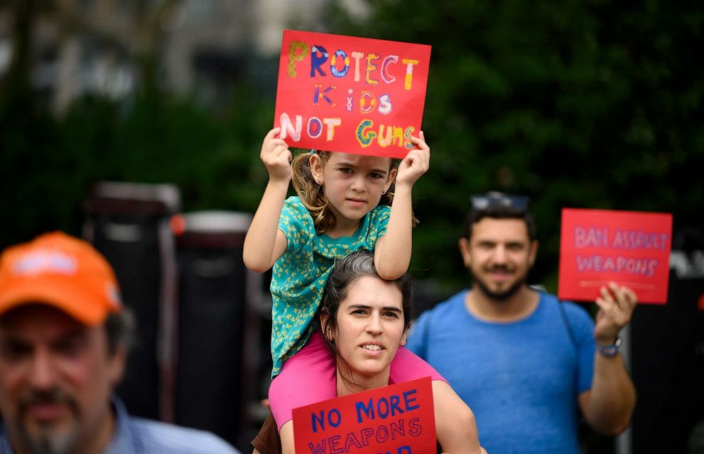 PHOTO: A woman holds her child as she takes part in a rally of Moms against gun violence and calling for Federal Background Checks on Aug. 18, 2019 in New York City.