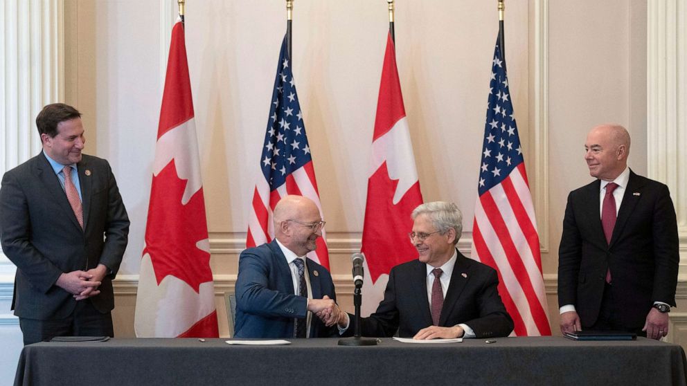 PHOTO: Minister of Justice and Attorney General of Canada David Lametti and U.S. Attorney General Merrick Garland shake hands after signing a document following the 2023 Canada-United States Cross-Border Crime Forum, Apr. 28, 2023 in Ottawa, Ontario.