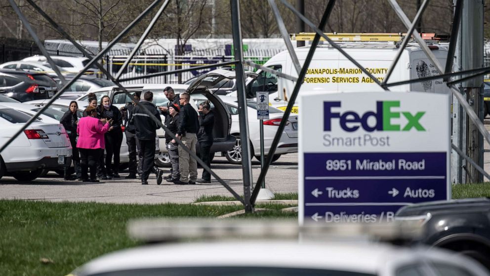PHOTO: In this April 16, 2021, file photo, a group of crime scene investigators gather to speak in the parking lot of a FedEx SmartPost in Indianapolis.