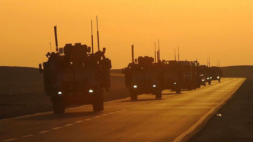 PHOTO: A convoy of armored vehicles drive toward Camp Beuhring, Kuwait, in 2011.