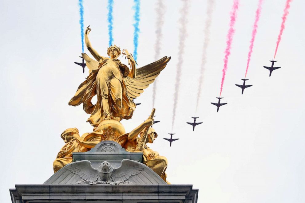 PHOTO: The Royal Air Force Aerobatic Team otherwise known as The Red Arrows fly over The Queen Victoria Memorial during the Coronation of King Charles III and Queen Camilla, May 06, 2023 in London.