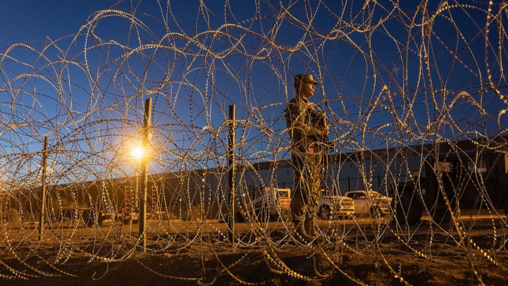 PHOTO: EL PASO, TEXAS - MAY 11: A Texas National Guard soldier stands vigil at a makeshift migrant camp near the U.S.-Mexico border fence on May 11, 2023 in El Paso, Texas.