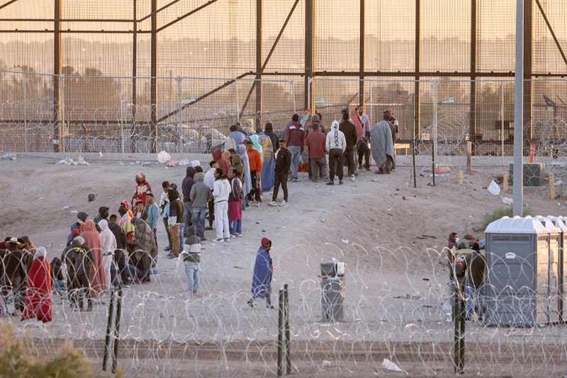 EL PASO, TEXAS - MAY 12: Immigrants wait to be transported and processed by U.S. Border Patrol officers at the U.S.-Mexico border on May 12, 2023 in El Paso, Texas. The U.S. Covid-era Title 42 immigration policy ended the night before, and migrants entering the system now are anxious over how the change may affect their asylum claims. (Photo by John Moore/Getty Images)