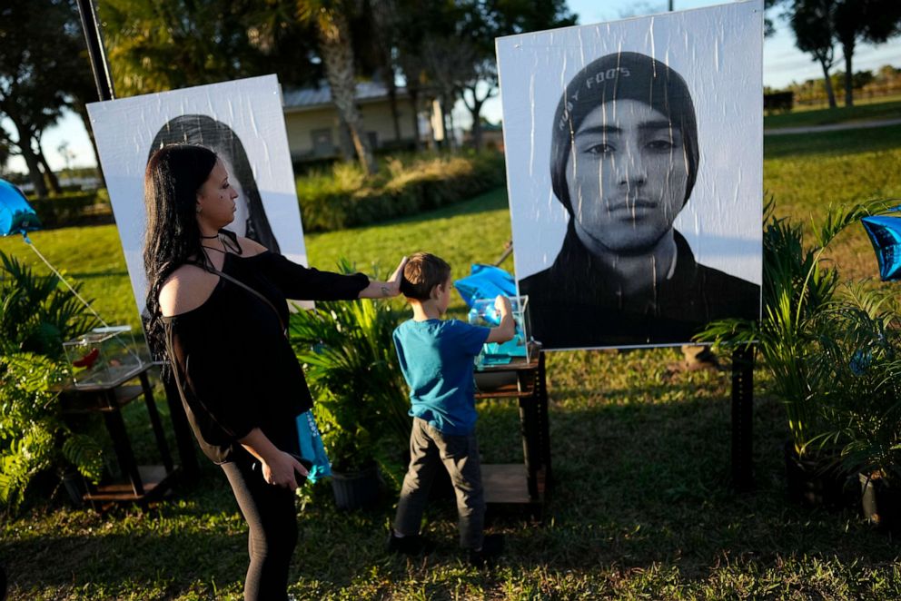 PHOTO: In this Feb. 14, 2023, file photo, Mariana Rocha visist a portrait of Rocha's cousin Joaquin Oliver, during a community commemoration on the five-year anniversary of the shooting, at Pine Trails Park in Parkland, Fla.