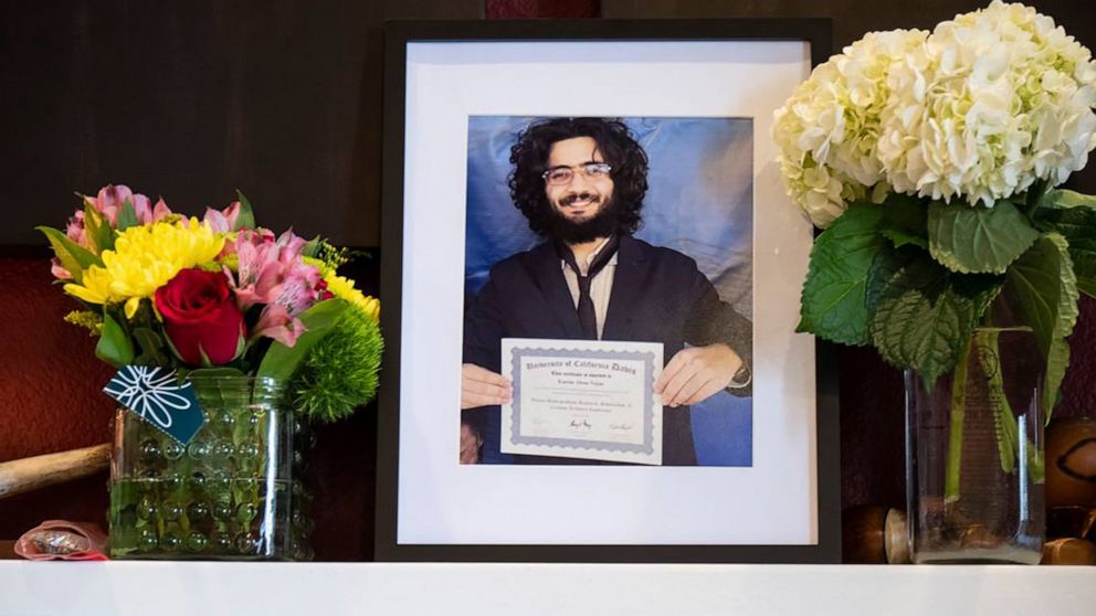 PHOTO: A portrait of Karim Abou Najm stands amid flowers on the fireplace mantel of his family home in Davis, Calif., May 1, 2023.