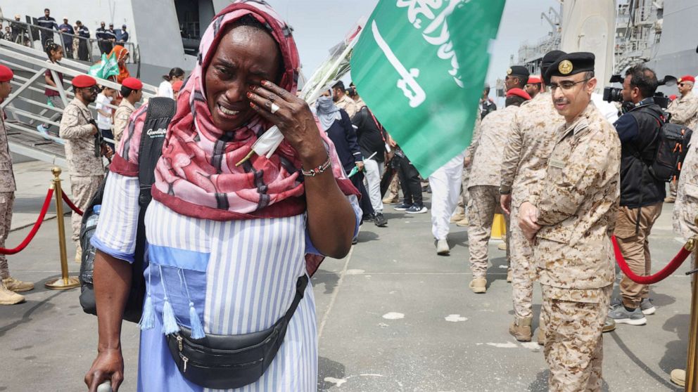 PHOTO: A woman cries as she disembarks from Saudi Navy Ship after being evacuated to Saudi Arabia from Sudan, to escape the conflict, May 8, 2023, at the Jeddah Sea Port, Saudi Arabia.