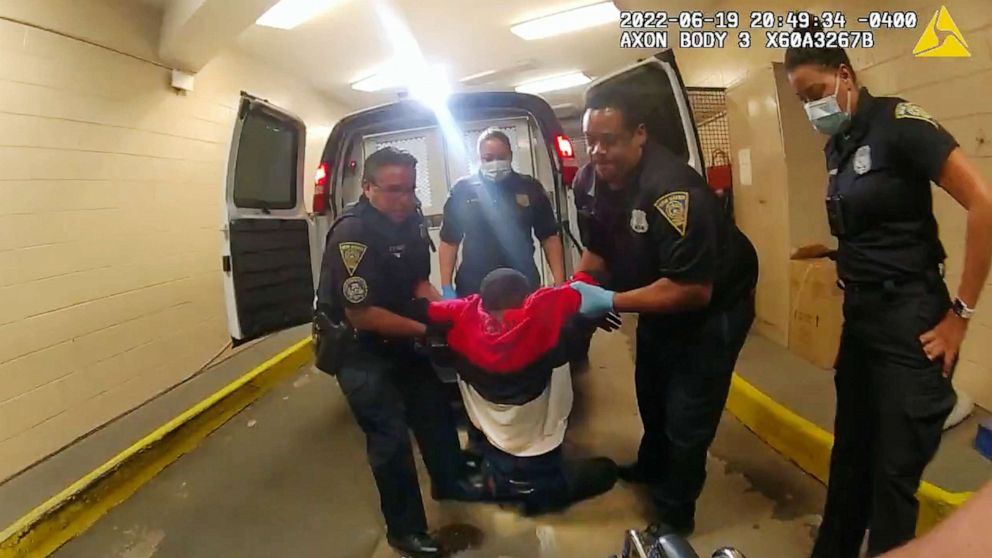 PHOTO: In this image taken from police body camera video provided by New Haven Police, Richard "Randy" Cox is pulled from the back of a police van and placed in a wheelchair after being detained by New Haven Police, June 19, 2022, in New Haven, Conn.