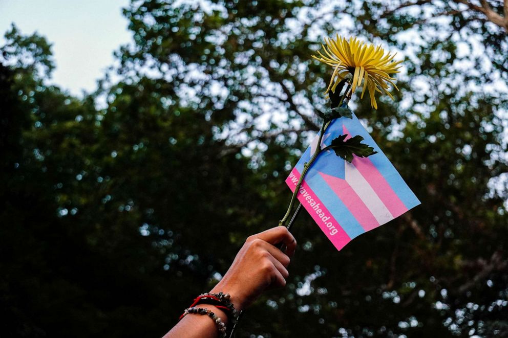 PHOTO: FILE - A person holds a transgender pride flag and a flower during a Black Trans Liberation protest in New York,May 31, 2023.