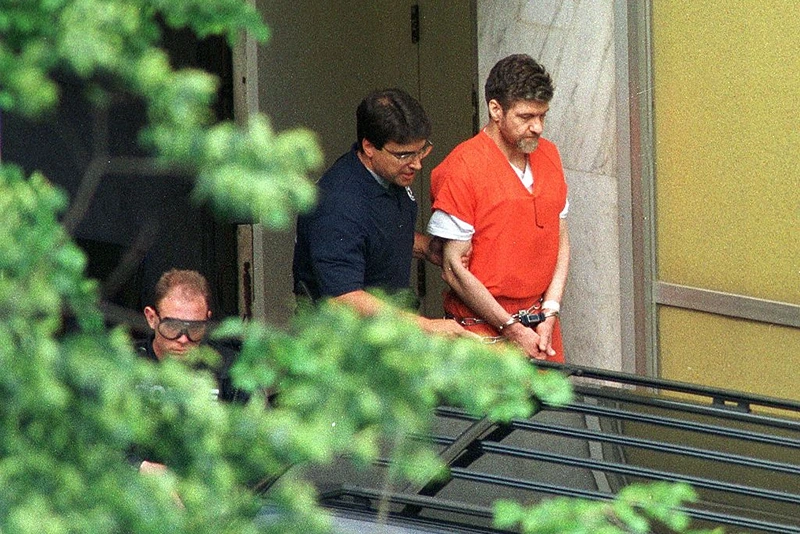 Convicted Unabomber Theodore Kaczynski is escorted by US Marshals outside the Sacramento County Federal Court, Sacramento, California, May 4, 1998. Kaczynski was given four consecutive life sentences. AFP PHOTO/POOL (Photo credit should read RICH PEDRONCELLI/AFP via Getty Images)