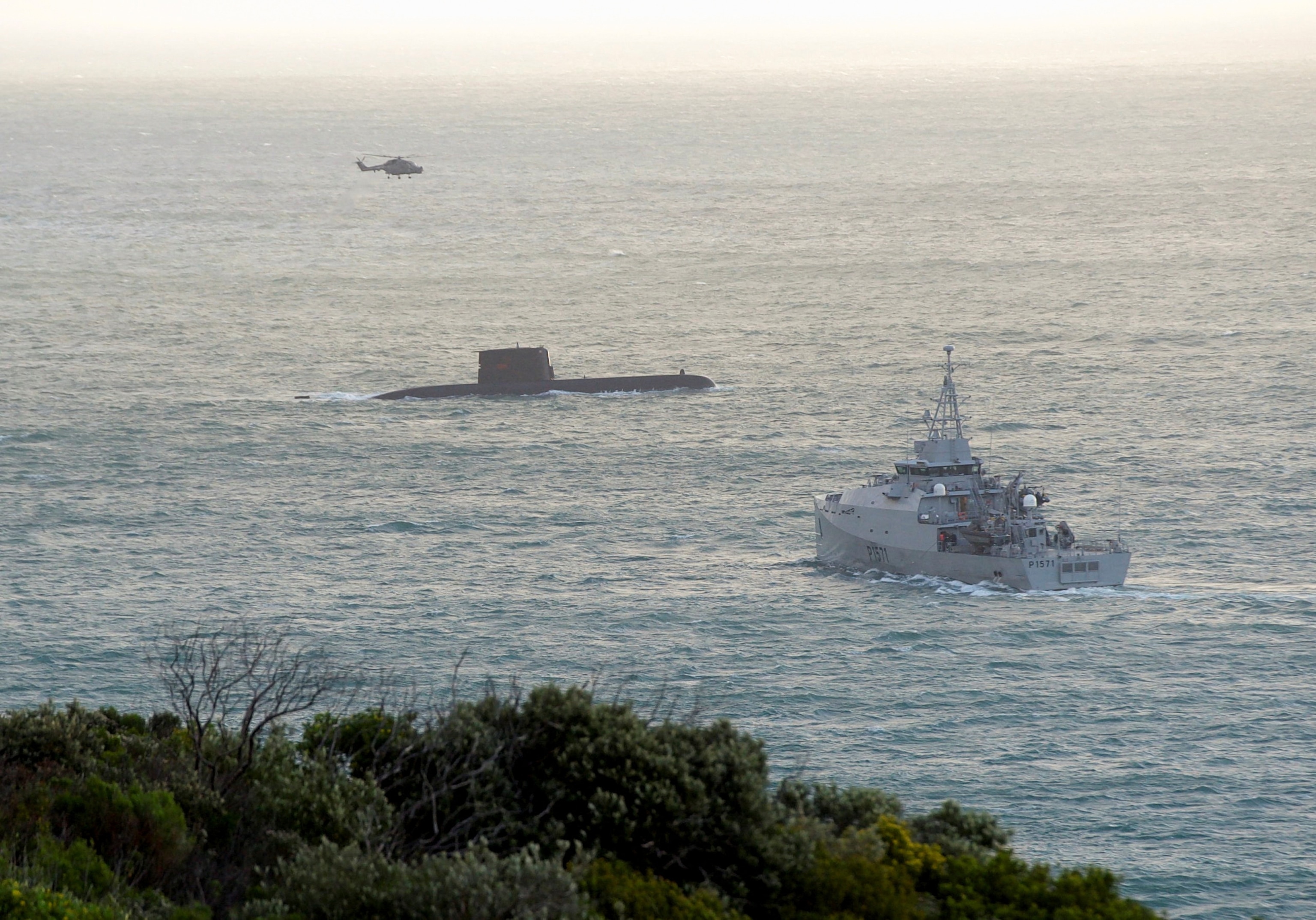 PHOTO: A South African Navy vessel, a submarine and a helicopter are seen near Hout Bay, following an incident with a South Africa Navy submarine during exercises off Kommetjie in Cape Town, South Africa Sept. 20, 2023.