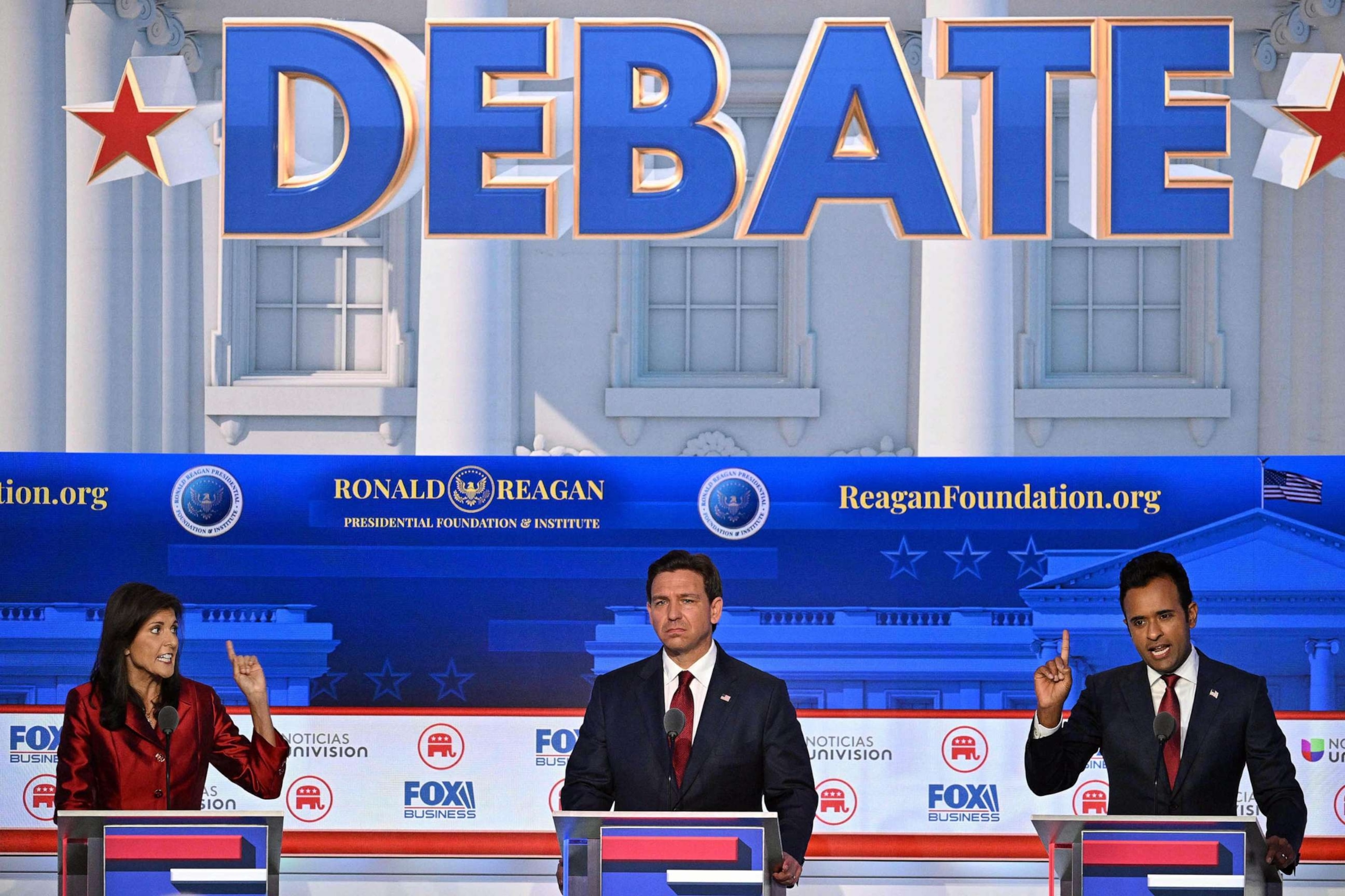 PHOTO: Florida Governor Ron DeSantis looks on as entrepreneur Vivek Ramaswamy and former Governor from South Carolina and UN ambassador Nikki Haley gesture during the second Republican presidential primary debate at the Ronald Reagan Presidential Library