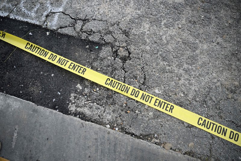 TOPSHOT-US-CRIME-SHOOTING TOPSHOT - Police tape is seen on the ground at the scene of a mass shooting in Monterey Park, California, on January 22, 2023. - Ten people have died and at least 10 others have been wounded in a mass shooting in a largely Asian city in southern California, police said, with the suspect still at large hours later. (Photo by Robyn BECK / AFP) (Photo by ROBYN BECK/AFP via Getty Images)