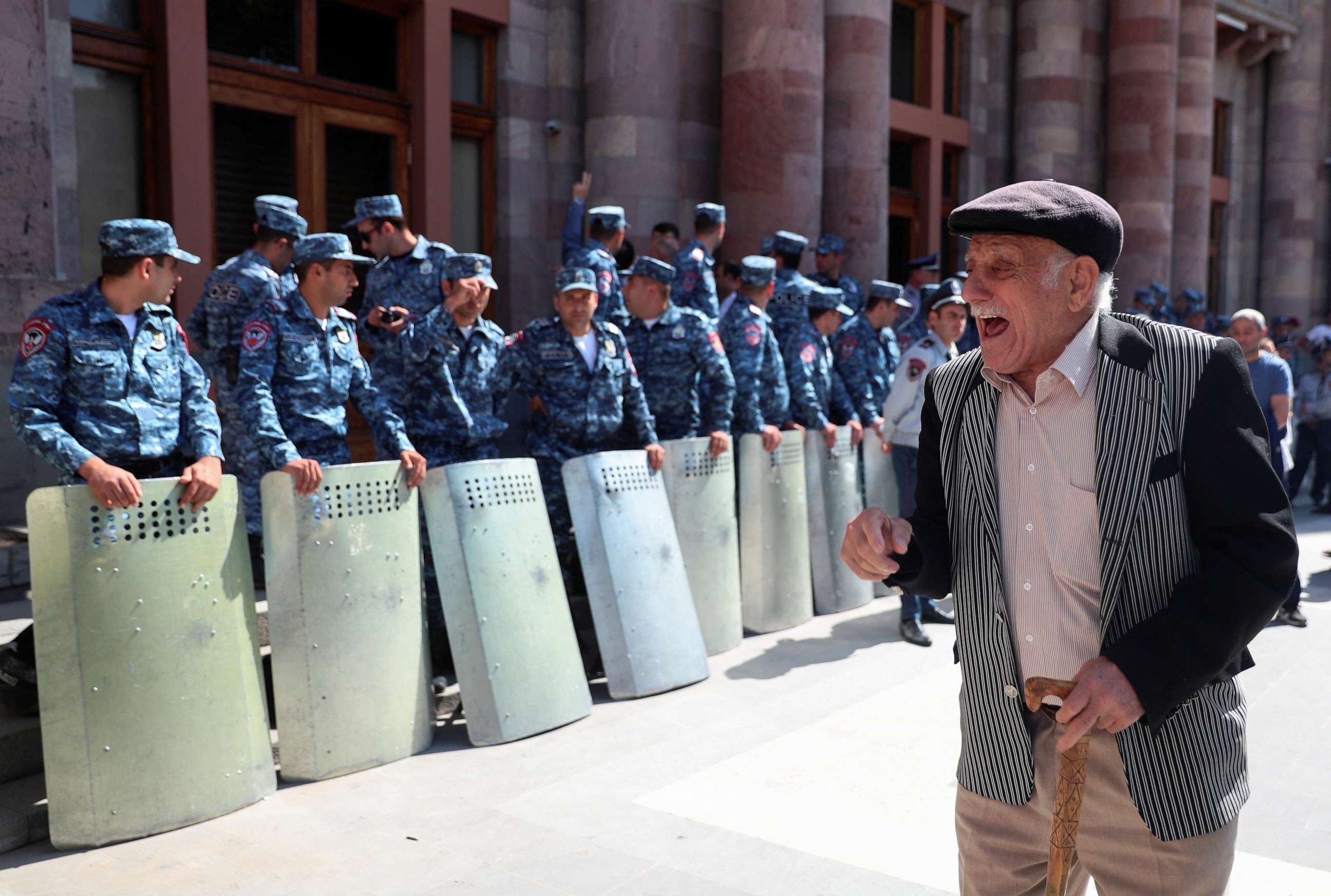 PHOTO: A protester reacts next to law enforcement officers during a gathering outside the government building following the launch of a military operation by Azerbaijani forces in the region of Nagorno-Karabakh, in Yerevan, Armenia, Sept. 20, 2023.