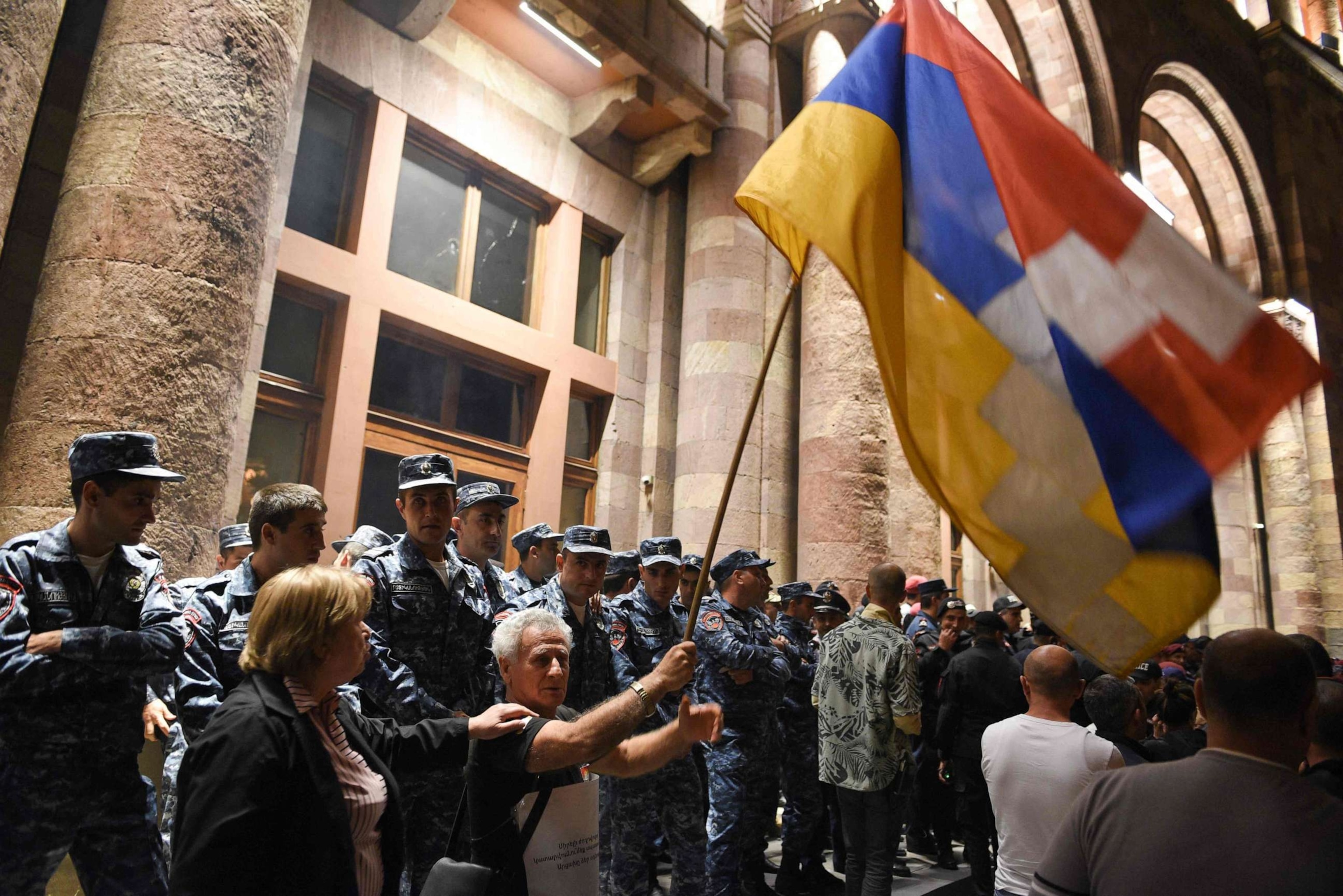 PHOTO: Armenian police officers guard the entrance to the government building during clashes with protesters calling on Armenian Prime Minister Nikol Pashinyan to resign in central Yerevan on Sept. 19, 2023.