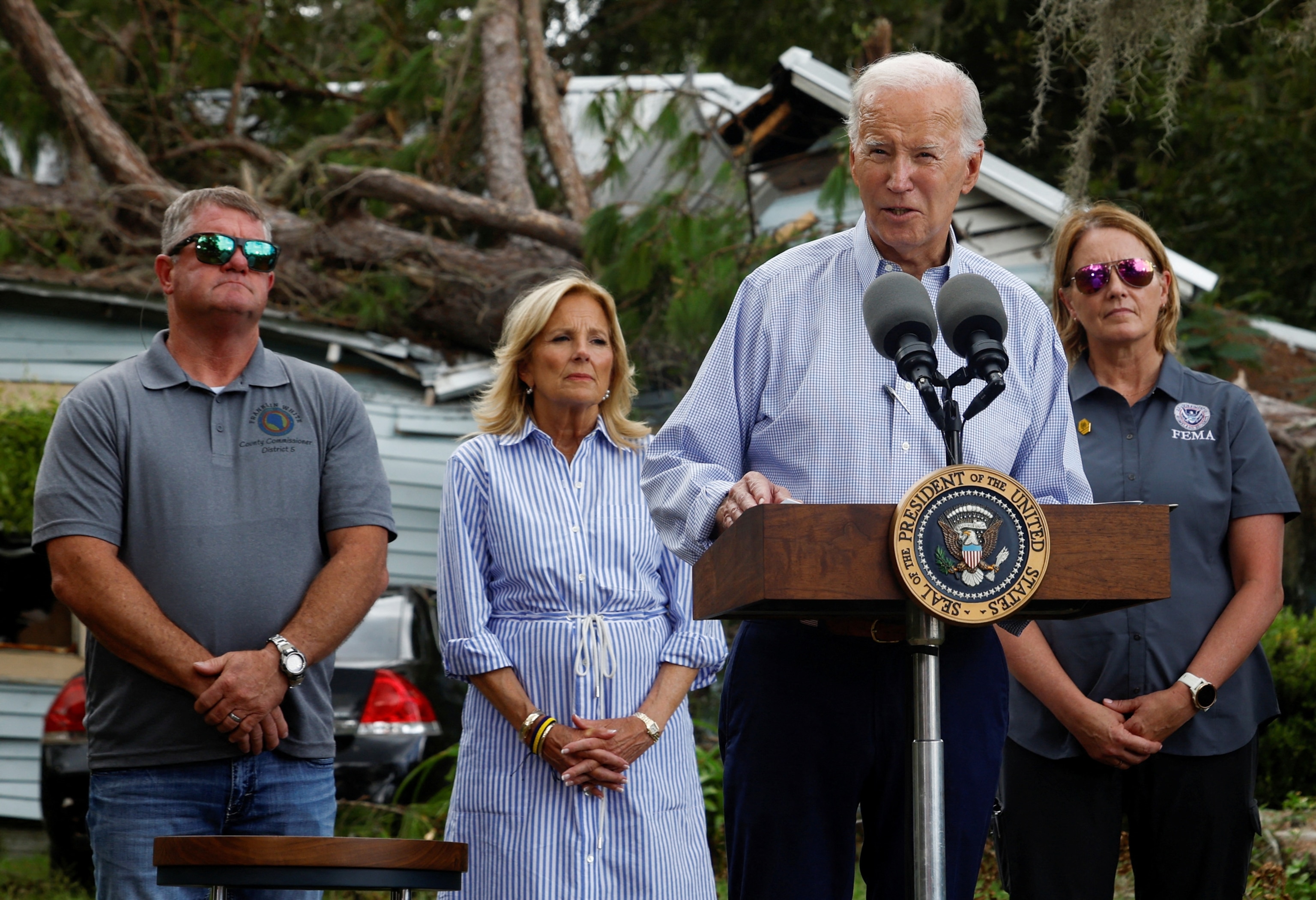 PHOTO: President Joe Biden speaks near a damaged building, in front of first lady Jill Biden, during their tour of Hurricane Idalia storm destruction, Live Oak, Fla., Sept. 2, 2023.