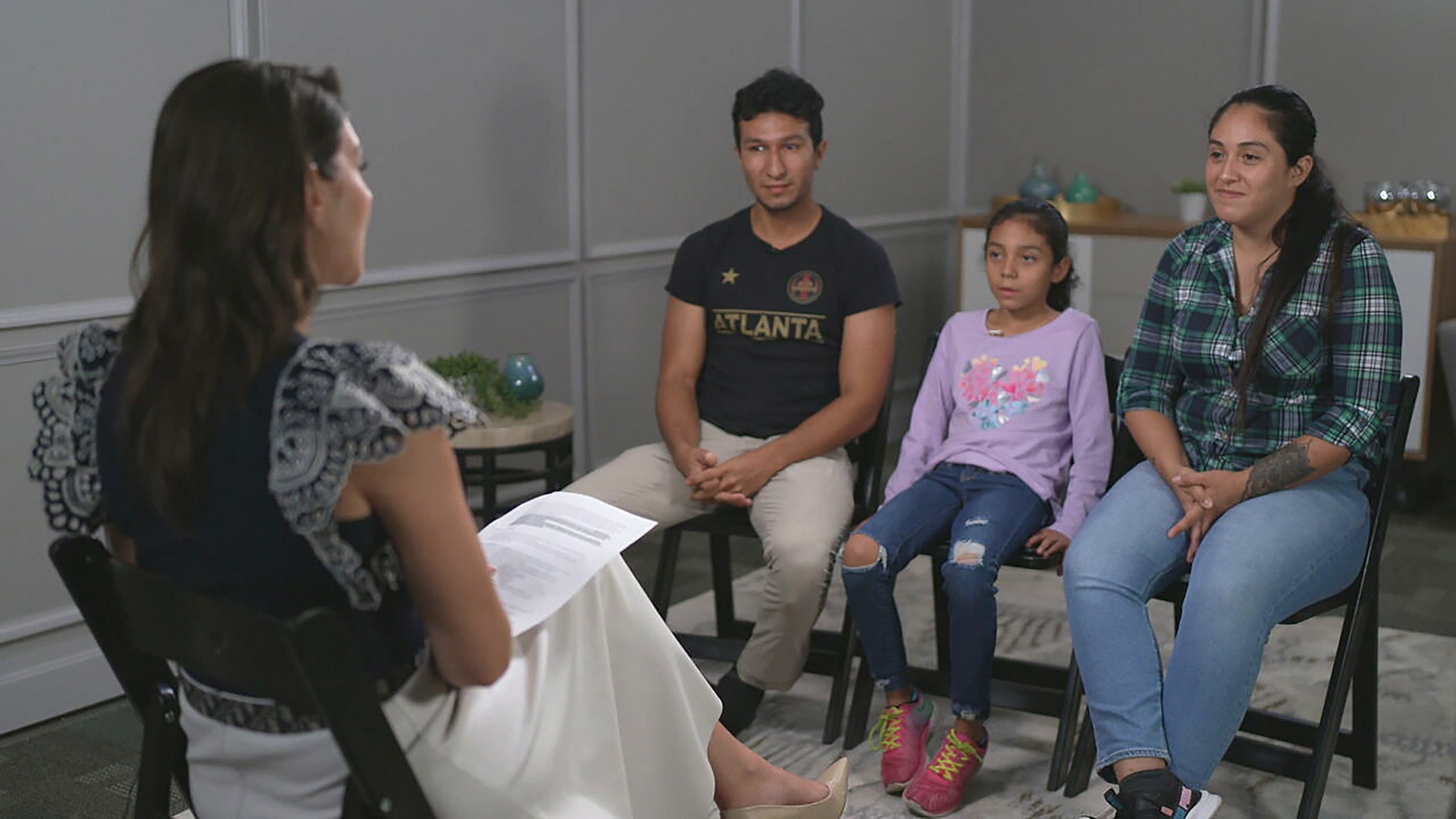 PHOTO: Ambar and Jaen, and their daughter Aranza, a migrant family of three from Colombia, are seen during an interview.