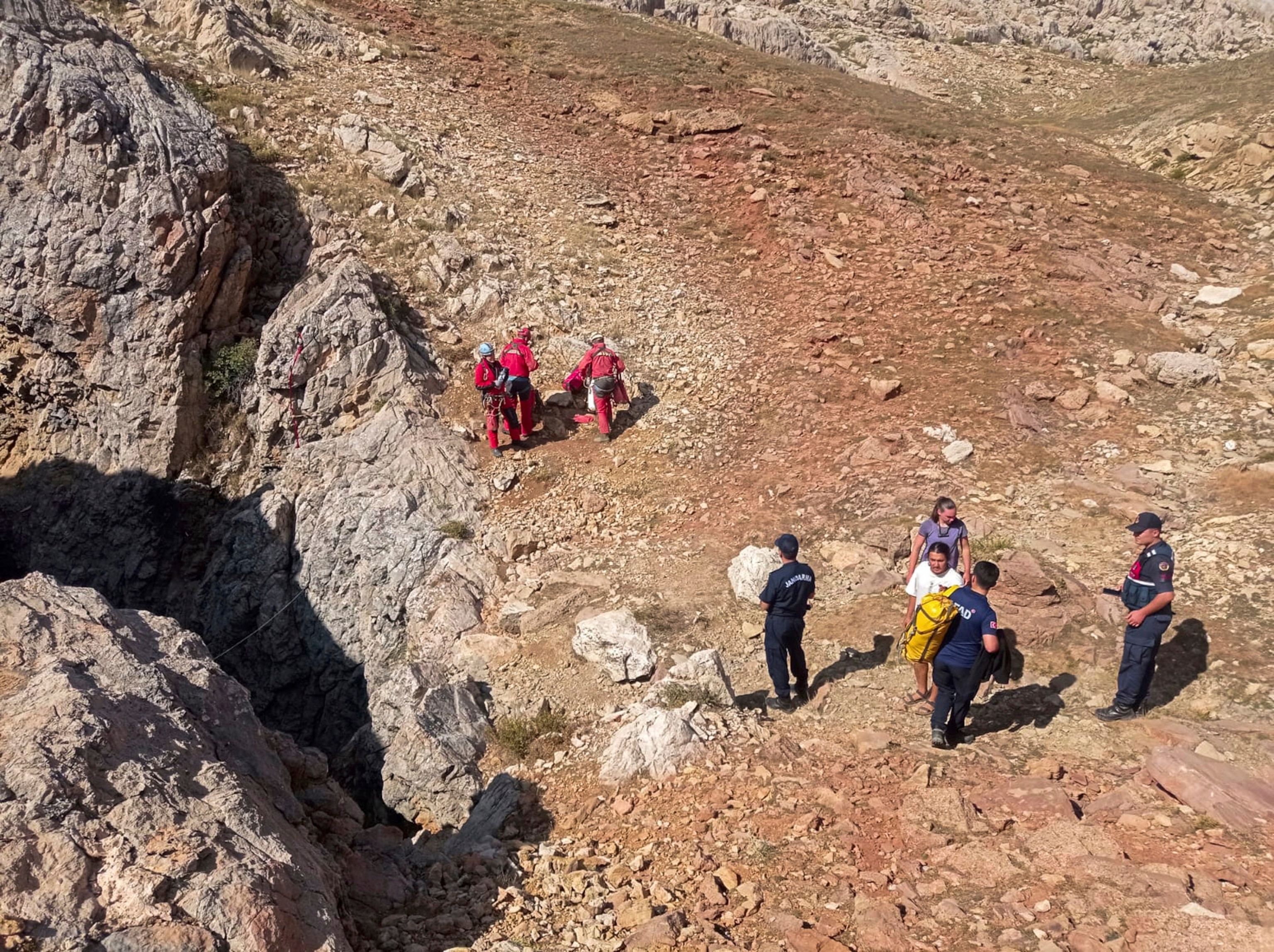 PHOTO: European Cave Rescue Association (ECRA) members and Turkish gendarmerie officers stand next to the entrance of Morca cave near Anamur, southern Turkey, Sept. 7, 2023.