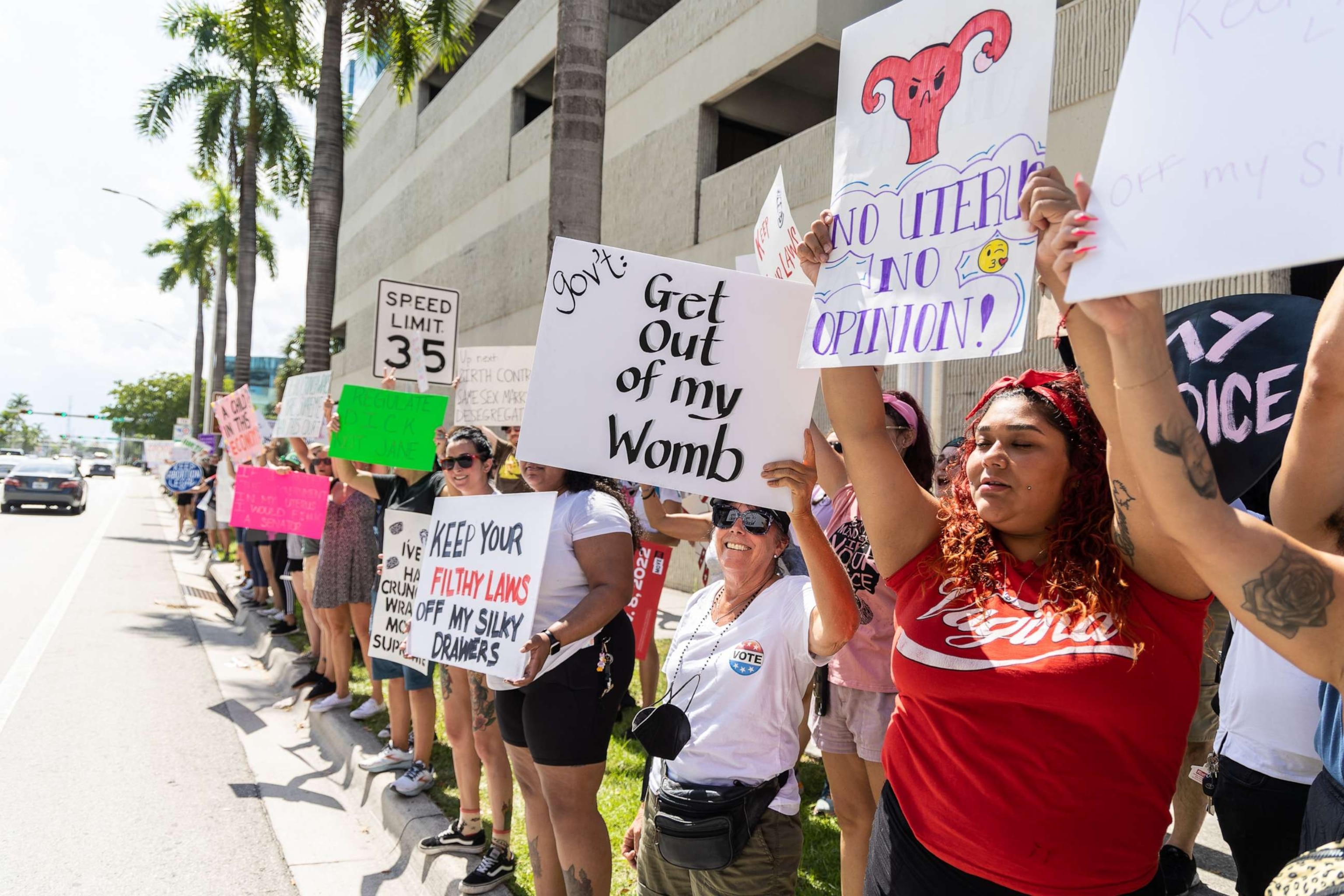 PHOTO: Abortion rights activists hold signs at a protest in support of abortion access, March To Roe The Vote And Send A Message To Florida Politicians That Abortion Access Must Be Protected And Defended, July 13, 2022, in Fort Lauderdale, Fla.
