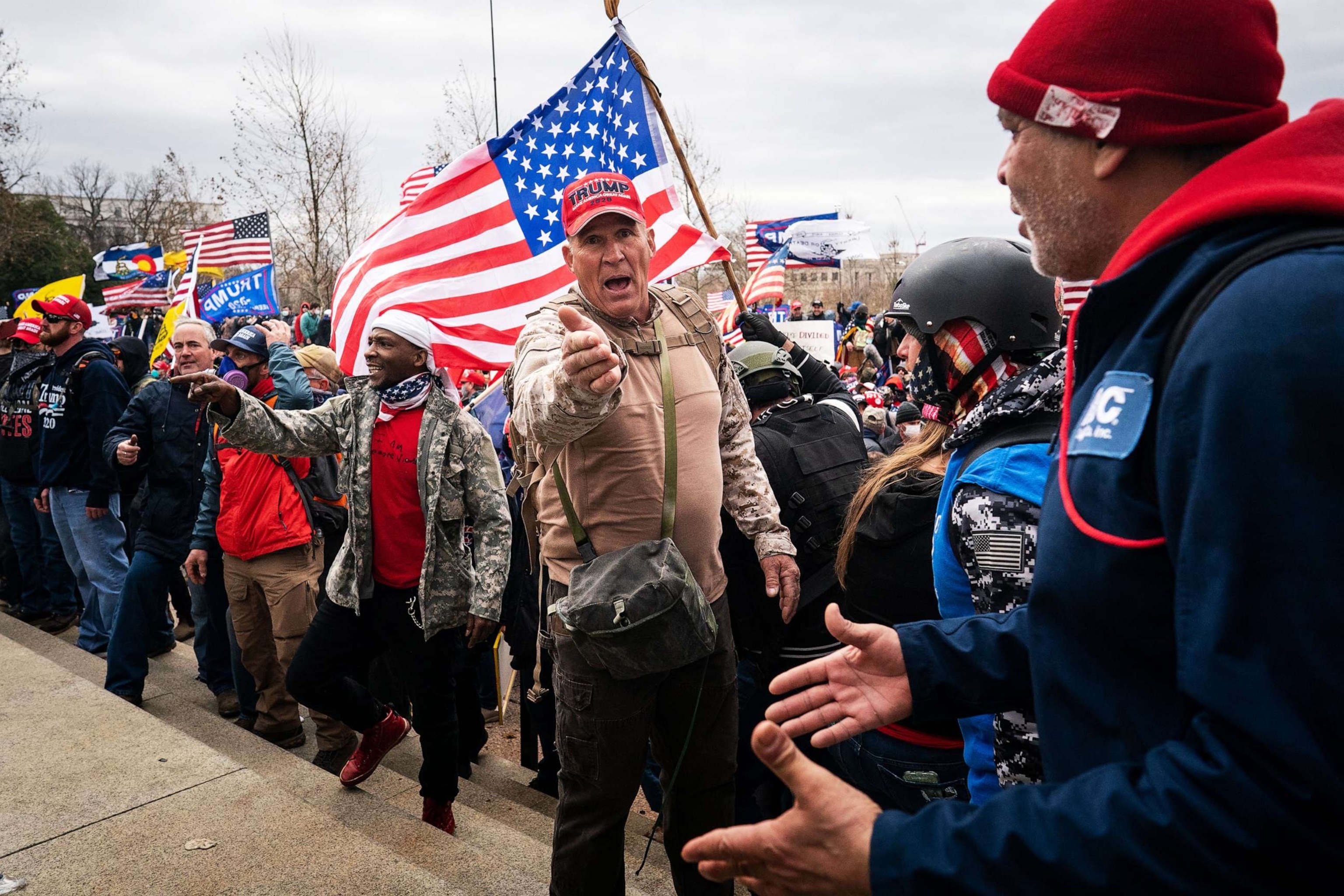 PHOTO: Ray Epps, in the red Trump hat, center, gestures to others as people gather on the West Front of the U.S. Capitol on Jan. 6, 2021, in Washington, D.C.