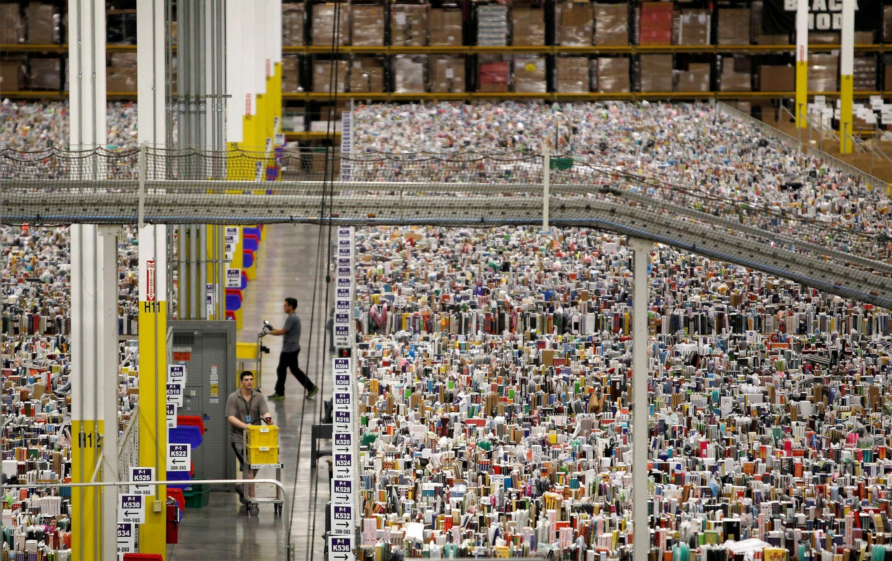 PHOTO: FILE - Workers gather items for delivery from the warehouse floor at Amazon's distribution center in Phoenix, Nov. 22, 2013.