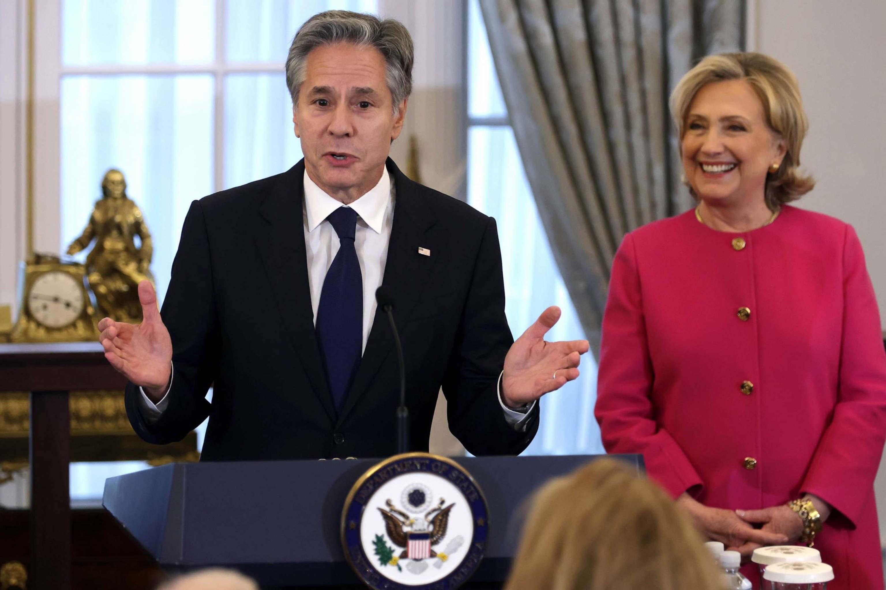 PHOTO: Secretary of State Antony Blinken speaks as former Secretary of State Hillary Clinton listens during an unveiling of her portrait at the State Department, Sept. 26, 2023 in Washington, DC.