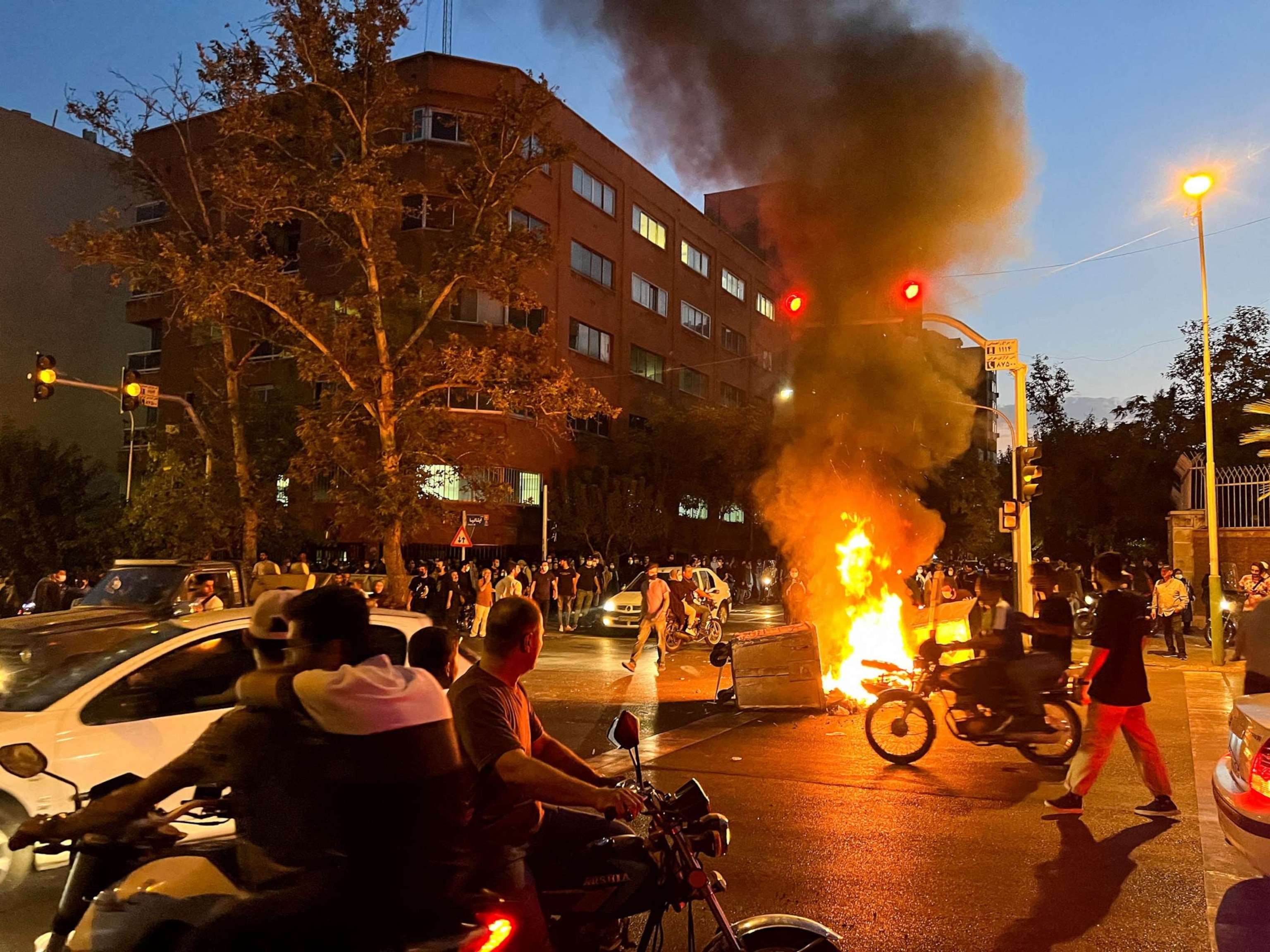 PHOTO: FILE - A police motorcycle burns during a protest over the death of Mahsa Amini, a woman who died after being arrested by the Islamic republic's "morality police", in Tehran, Iran Sept. 19, 2022.